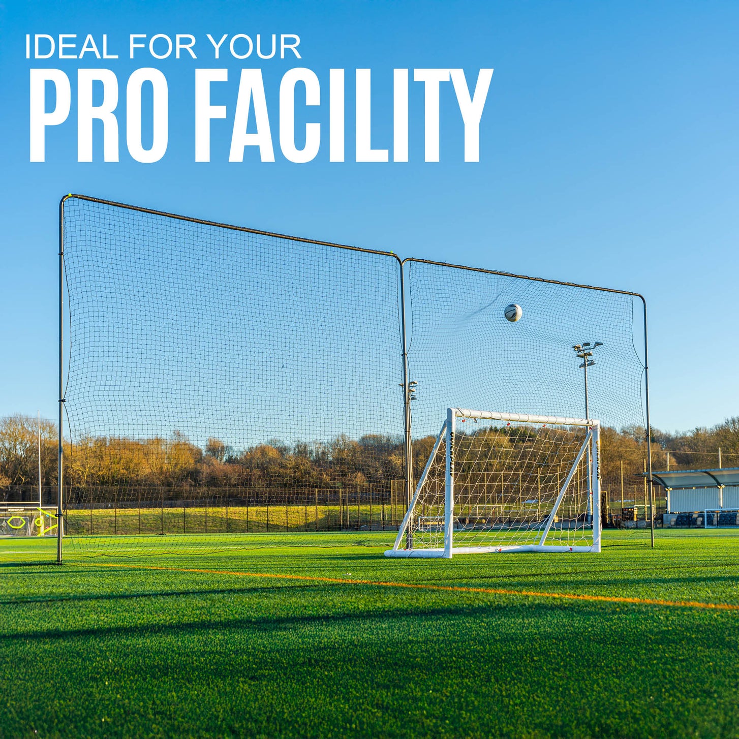 10ft Barrier Net System In-Ground: two panels on an artificial field behind a white goal as a ball hits the net, with the text "Ideal for your pro facility".