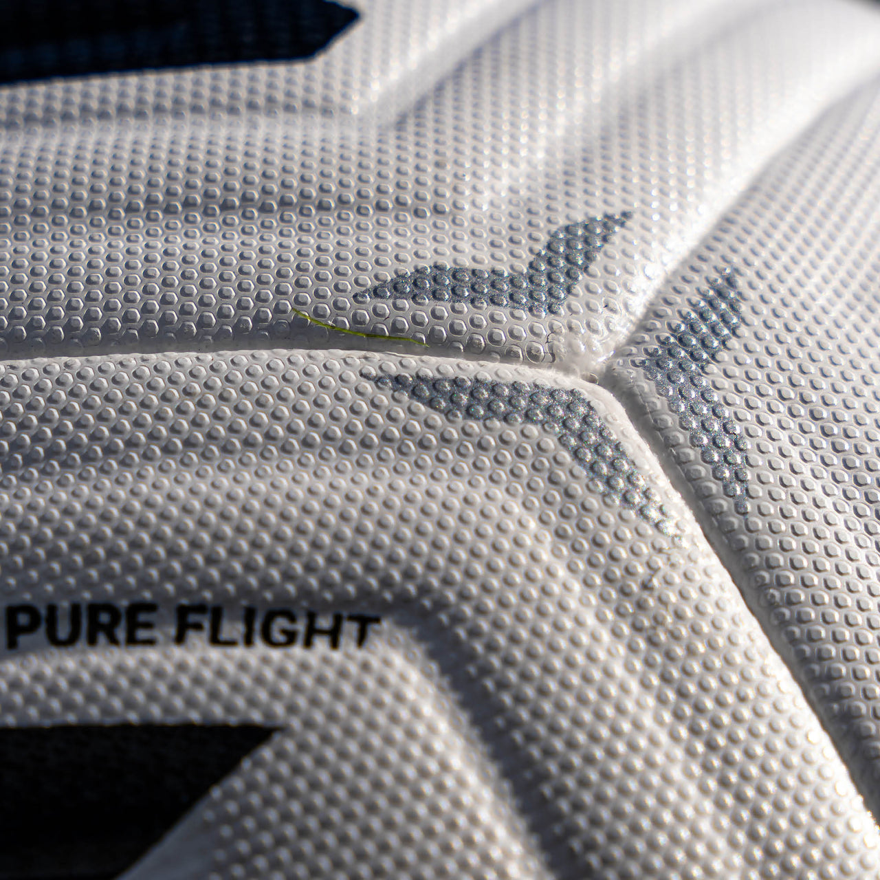 Close-up of an aerotech soccer ball with 'PURE FLIGHT' text and brand logo.