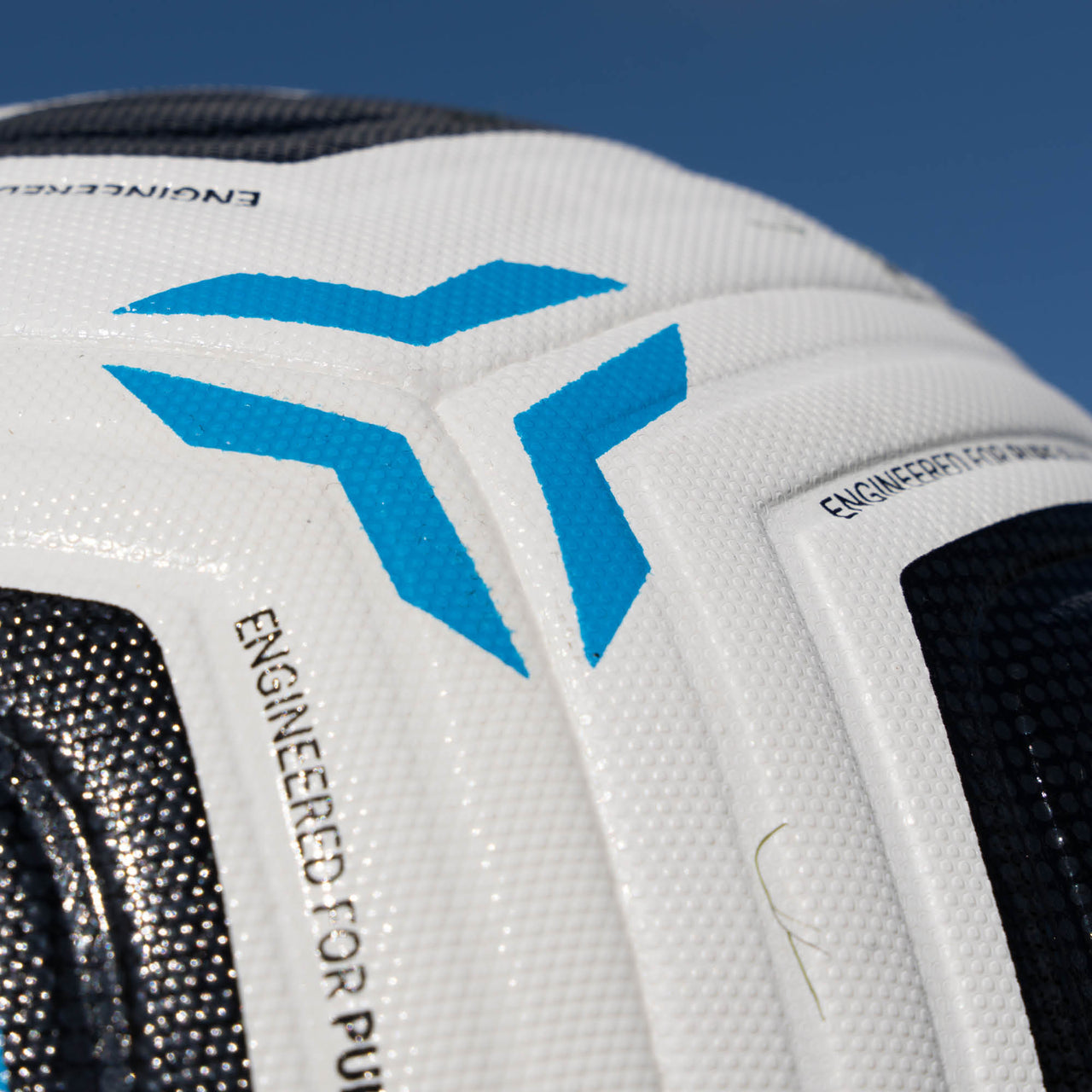 Close-up of a white Aerotech Match soccer ball with blue logo and text on a blue background