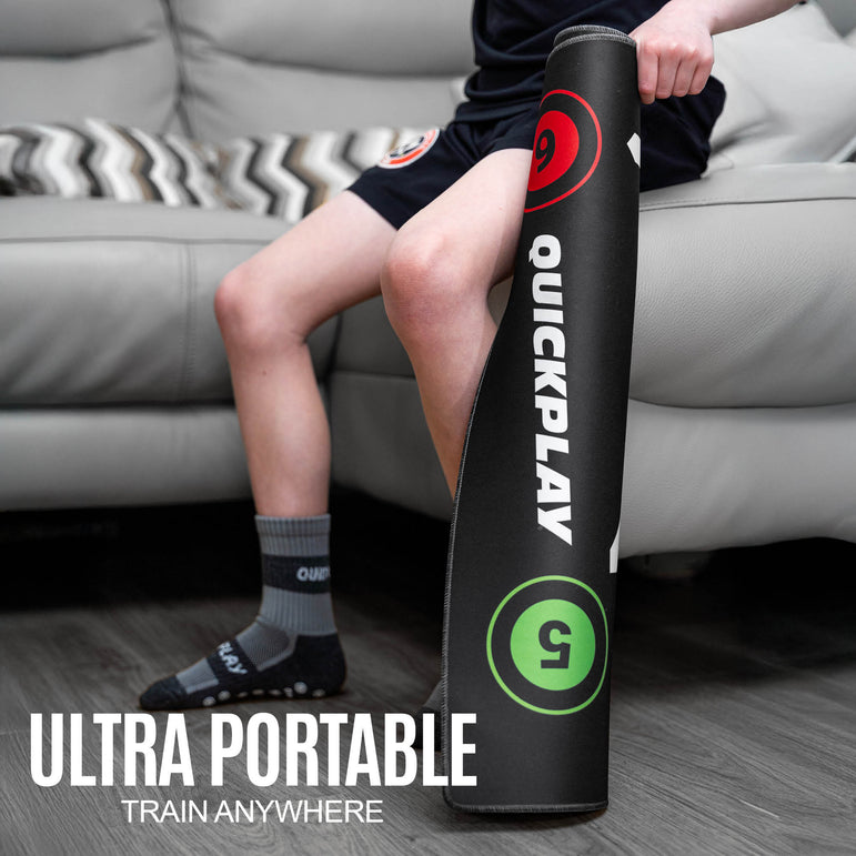 Person sitting on a couch with a QUICKPLAY ball mastery mat rolled up for portability.