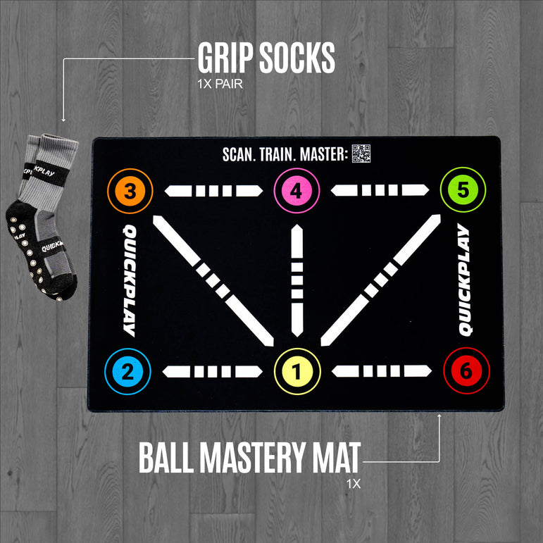 Ball mastery mat with QUICKPLAY branding and a single pair of grip socks on a wooden floor.