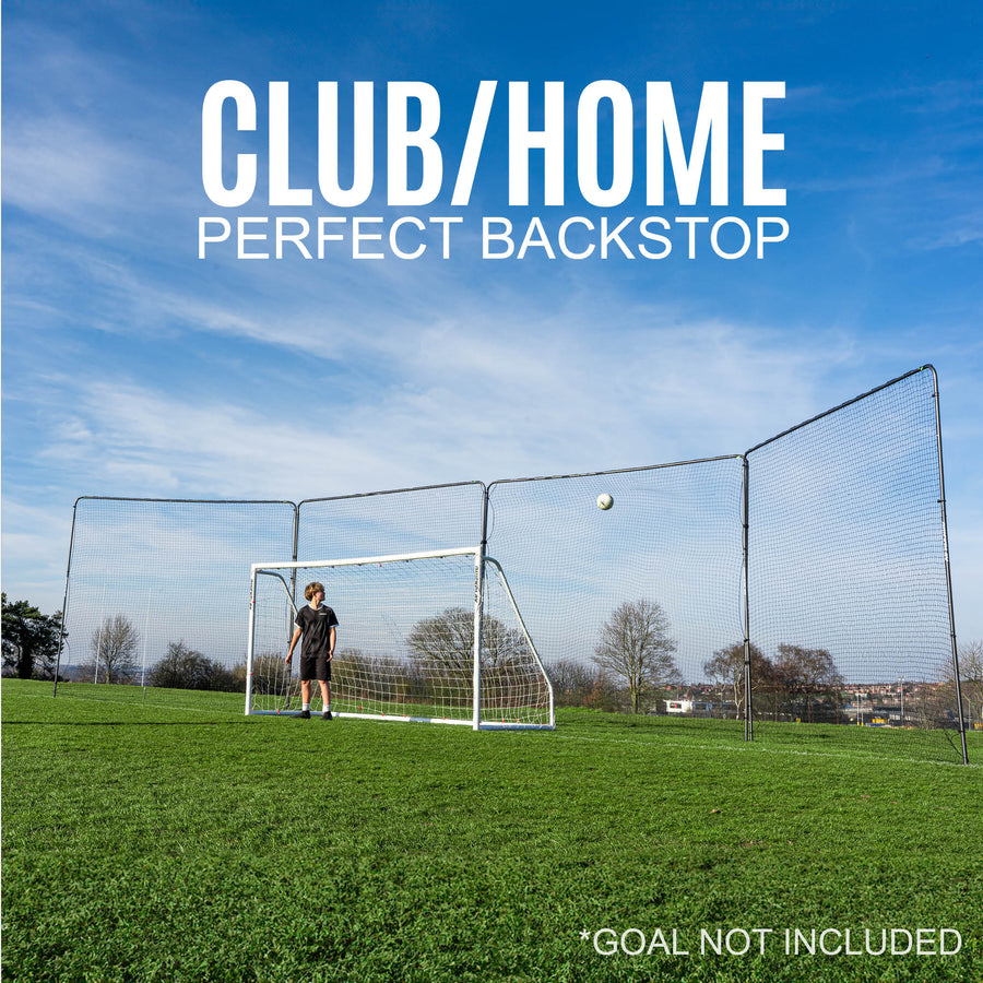 Soccer goal barrier net on a grass field with a clear blue sky.