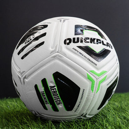 White Aerotech soccer ball with black and green branding on a grassy field