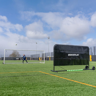 Soccer training device on a field with a clear sky