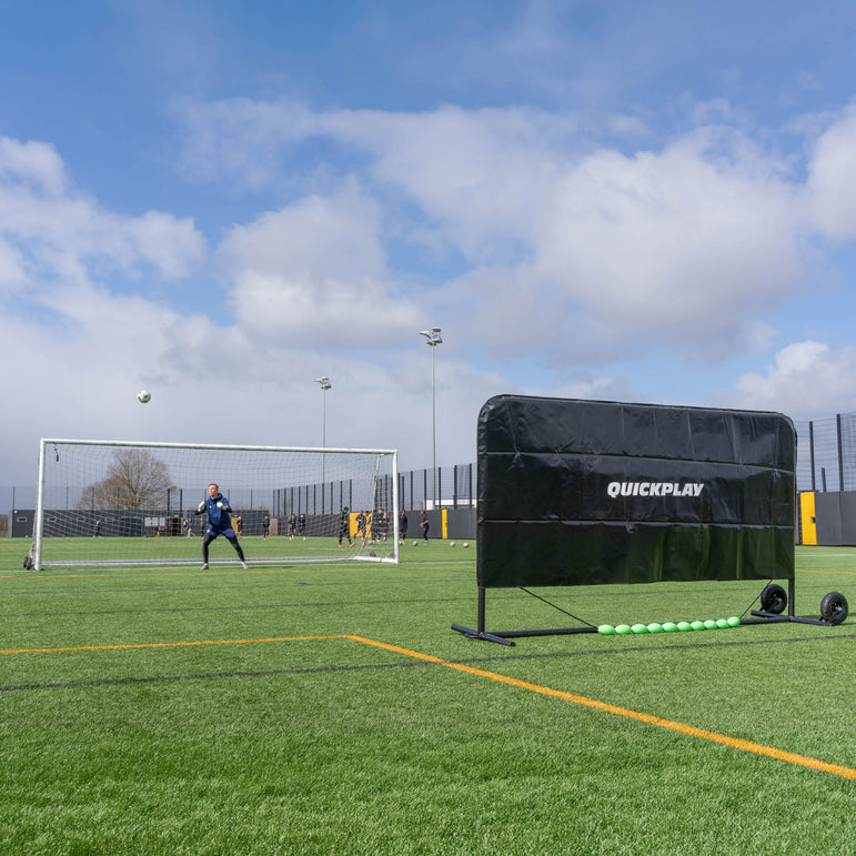 Soccer training device on a field with a clear sky