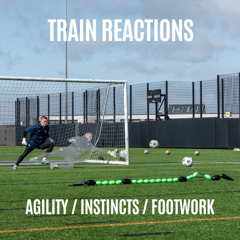 goalkeeper practicing soccer on a field with a goal and QUICKPLAY goalkeeper deflection line.
