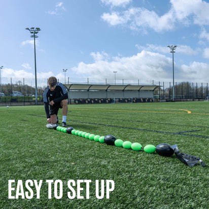 Green and black goalkeeper deflection line training equipment on gras