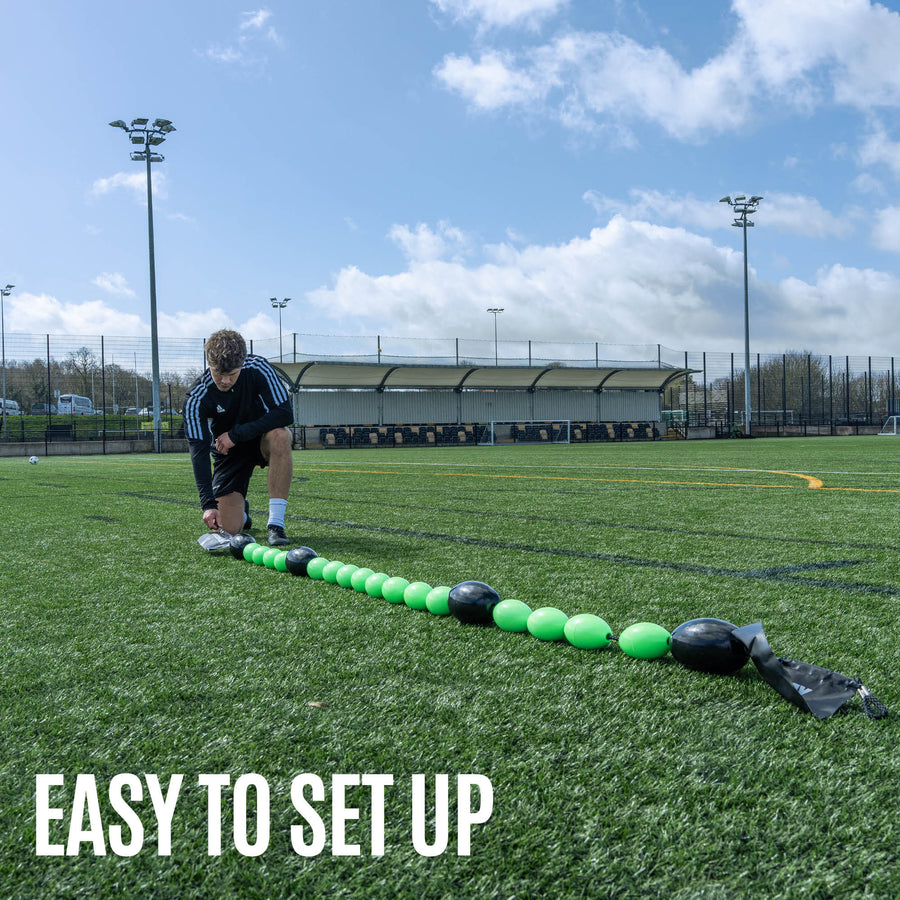 Green and black goalkeeper deflection line training equipment on gras