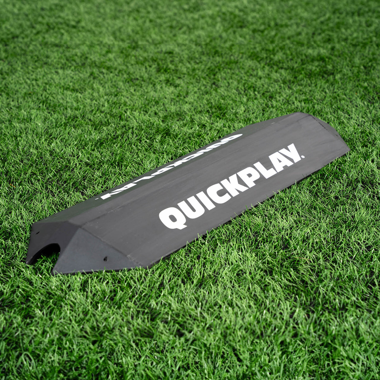 Black goalkeeper deflection ramp with 'QuickPlay' branding on a grass field
