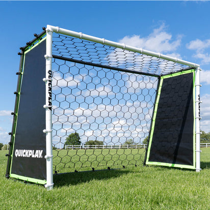 A green and black TEKKERS GS 3-in-1 goal with a rebound net on both sides, set on a grass surface.