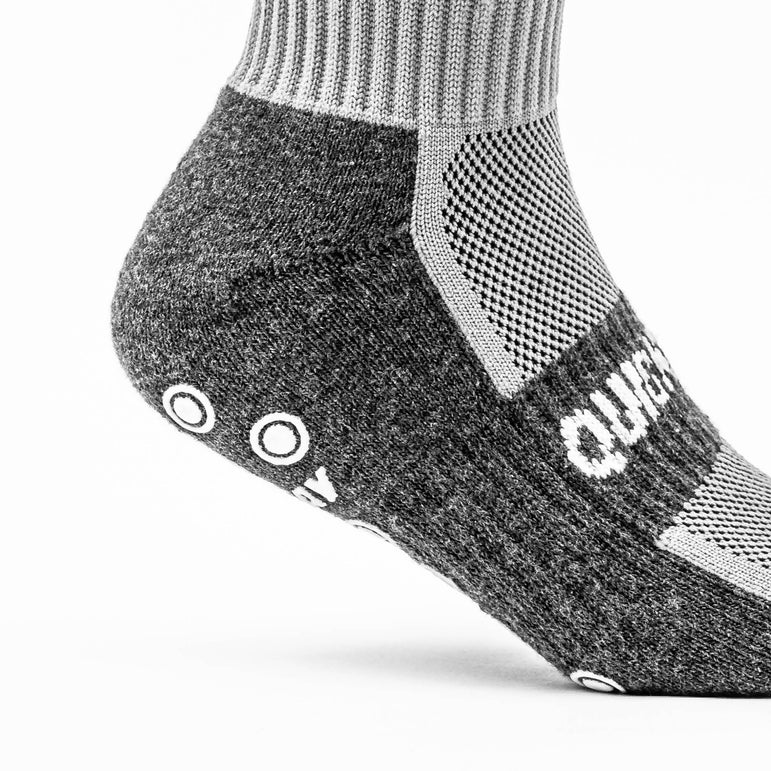 Gray and black sock with QUICKPLAY logo on a white background