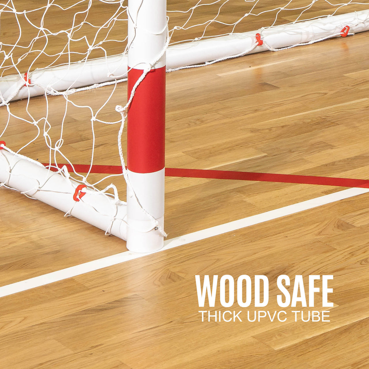 Wooden floor with a red and white Handball goal post, labeled 'Wood Safe Thick UPVC Tube'.
