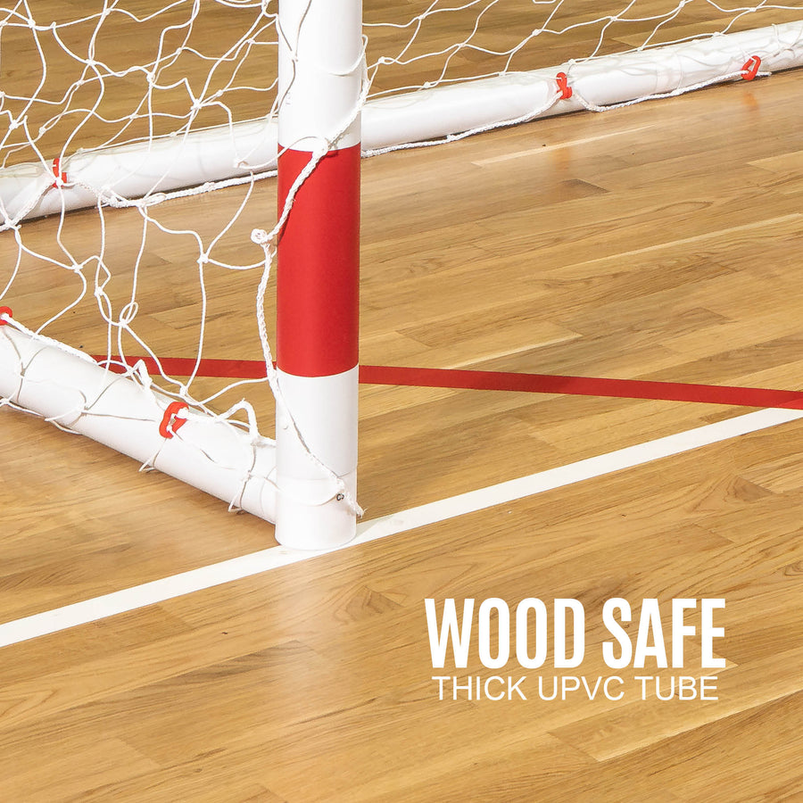 Wooden floor with a red and white Handball goal post, labeled 'Wood Safe Thick UPVC Tube'.