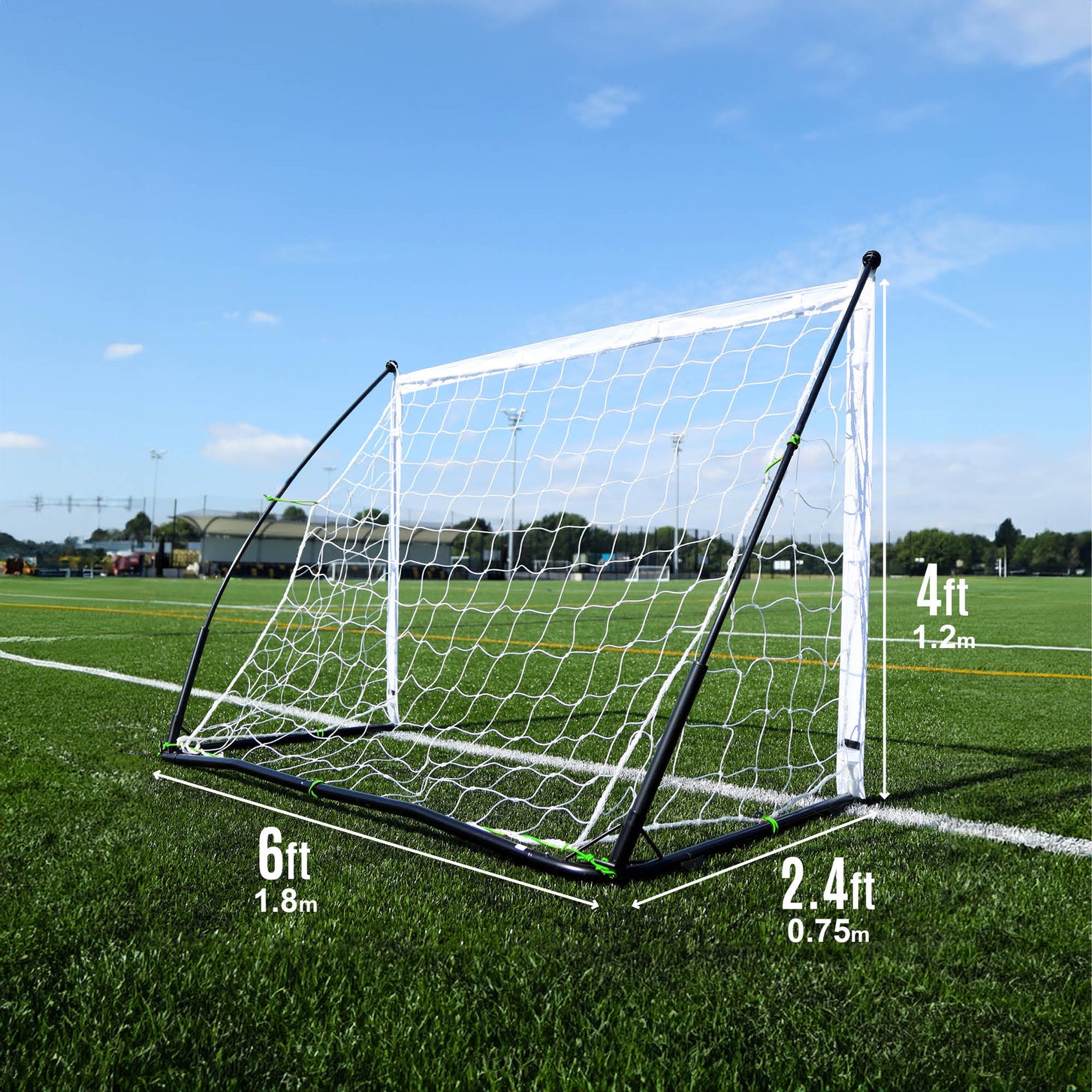 KICKSTER Elite 6x4' goal from the side on an artificial field, marked 6ft wide, 4ft high and 2.4ft deep.