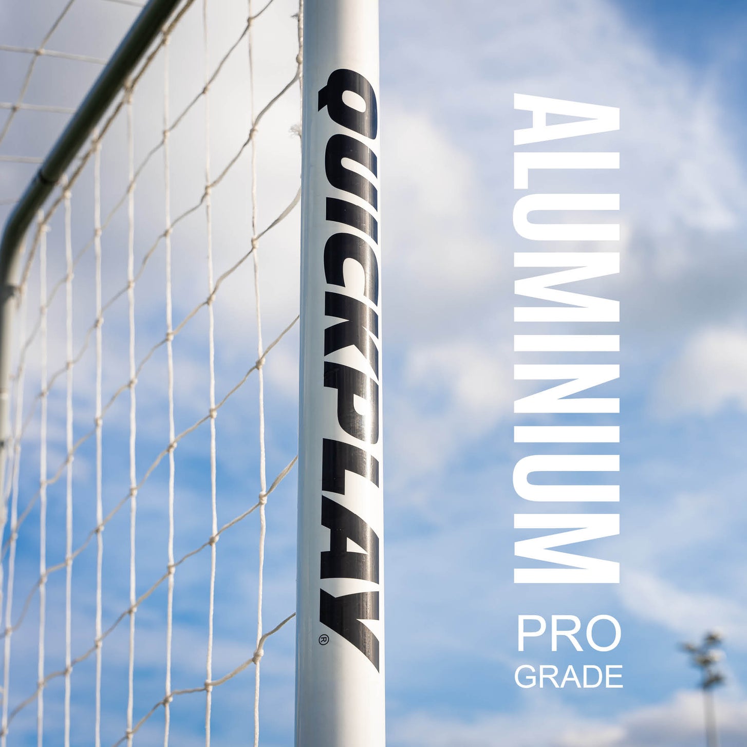 PRO ALU Match60 12x6' goal: close-up of the white QUICKPLAY upright and net against the sky, with text naming its pro grade aluminum frame.