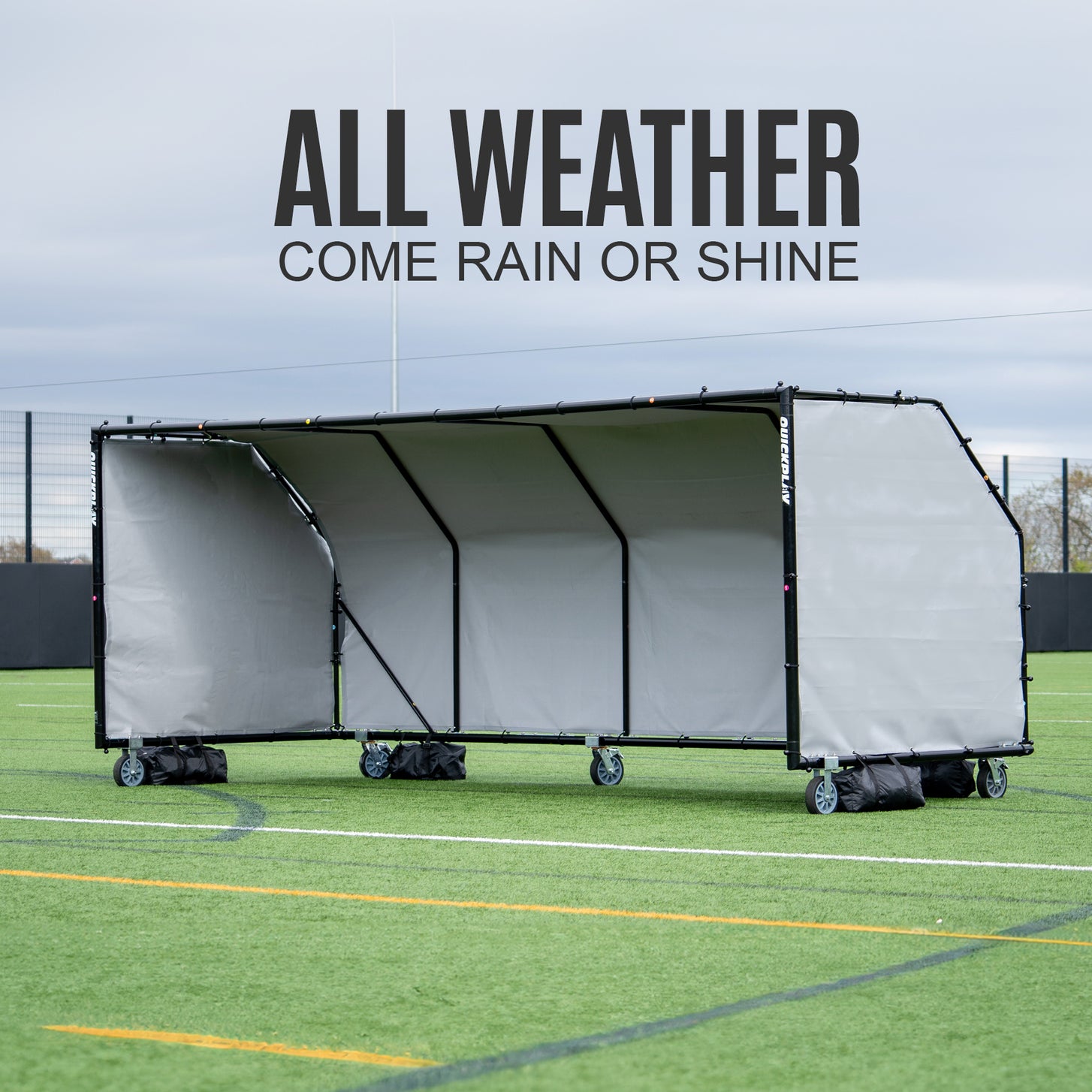 PRO ALU Club Shelter 16x6' on wheels with black bags at its base on a field, with the text "All weather, come rain or shine".