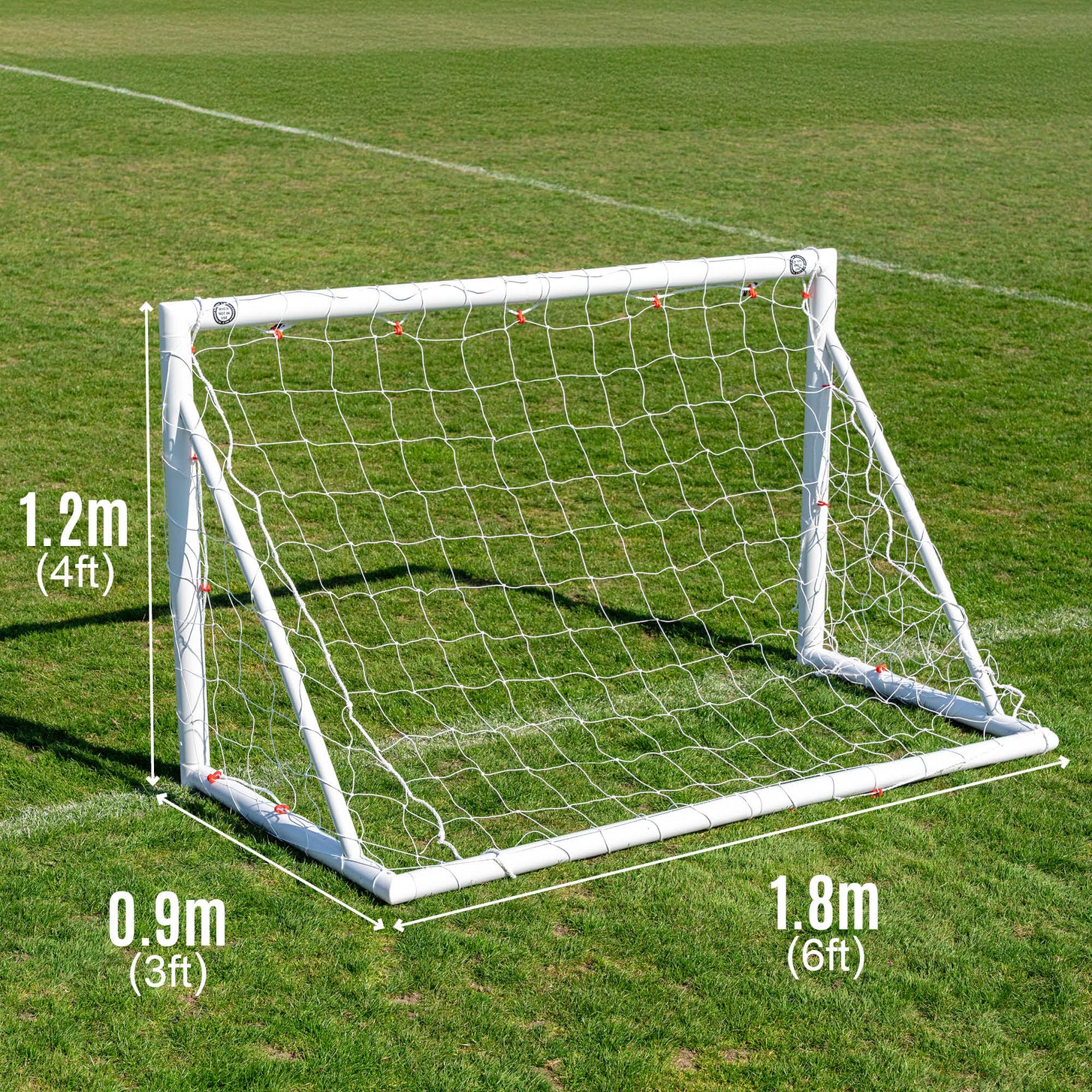 Q-FOLD 6x4' goal on a grass field marked 1.8m (6ft) wide, 1.2m (4ft) high and 0.9m (3ft) deep.