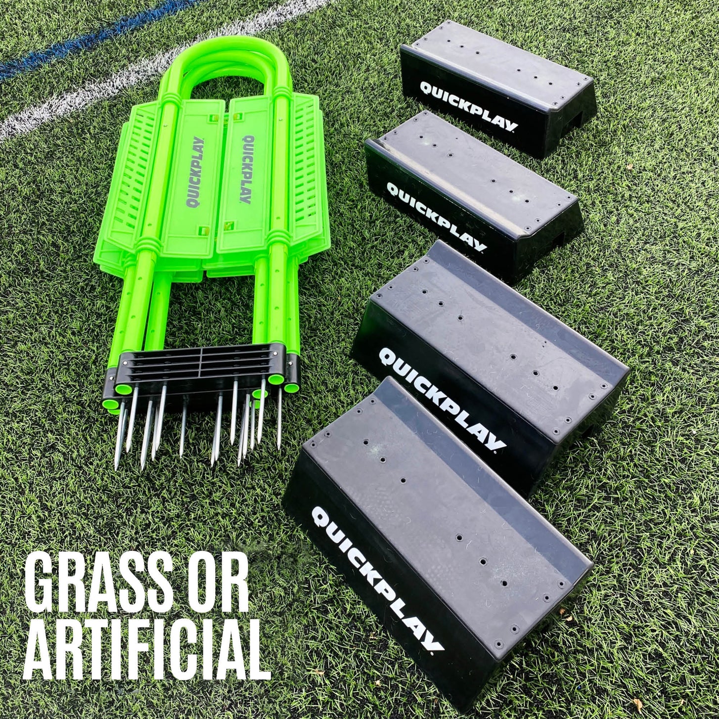 REPLAY Defender & Block System parts on turf: a folded green frame with metal spikes and four black QUICKPLAY bases, "Grass or artificial".