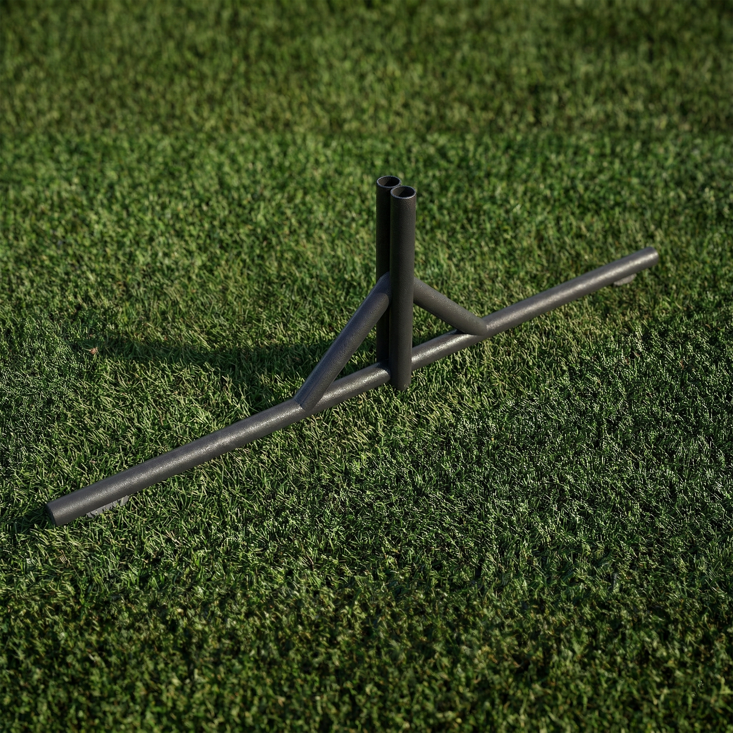 Metal barrier net stand on an astro turf field
