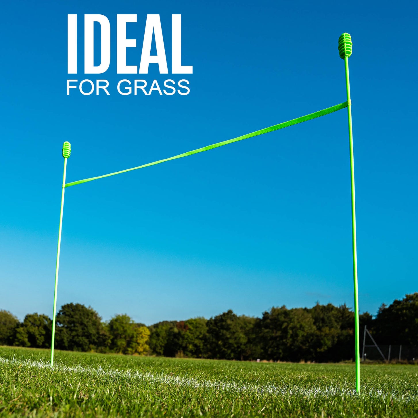 QUICKPLAY agility poles on grass with clear blue sky and trees in the background, text 'IDEAL FOR GRASS' above.