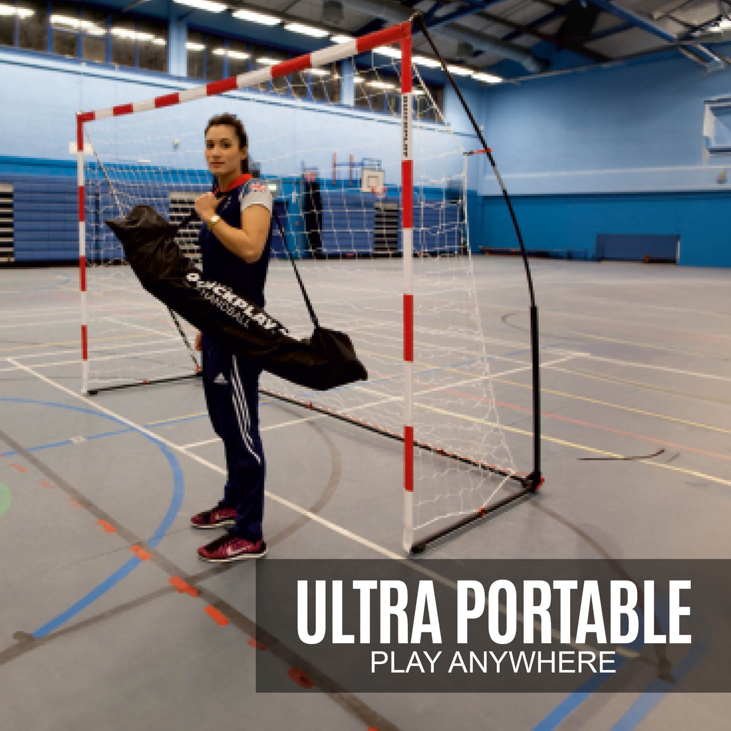 Portable Adult Handball Goal 9.8x6.5' in a sports hall with a woman holding a black QUICKPLAY handball bag, text "Ultra portable, play anywhere".