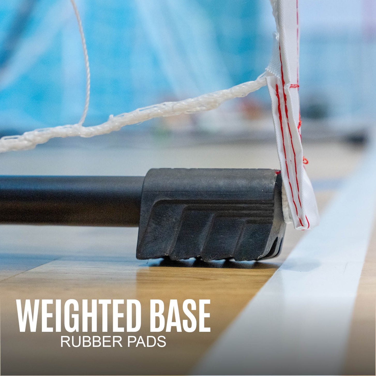 Portable Adult Handball Goal 9.8x6.5': close-up of a black rubber foot on the base bar, with the text "Weighted base, rubber pads".