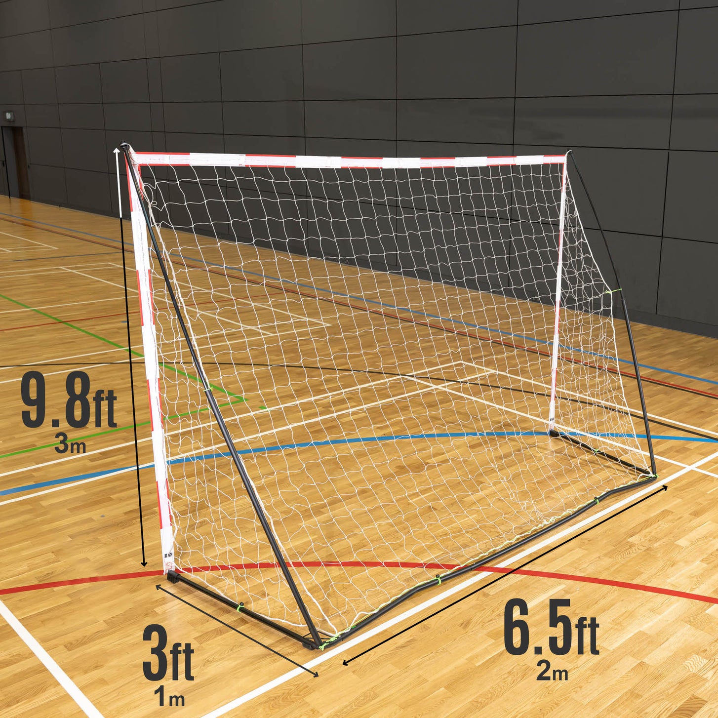 Portable Adult Handball Goal 9.8x6.5' in a sports hall with size labels: 9.8ft (3m) on the upright, 6.5ft (2m) along the base and 3ft (1m) deep.