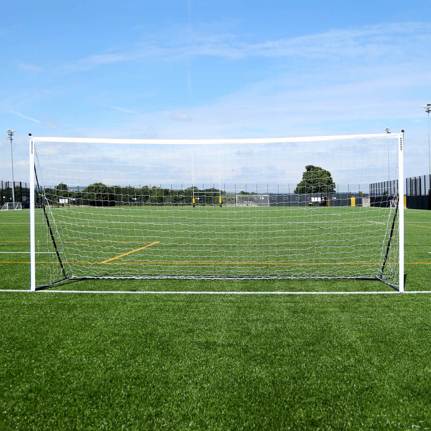 KICKSTER Elite 18.5x6.5' goal seen straight on from the front on an artificial field under a blue sky.
