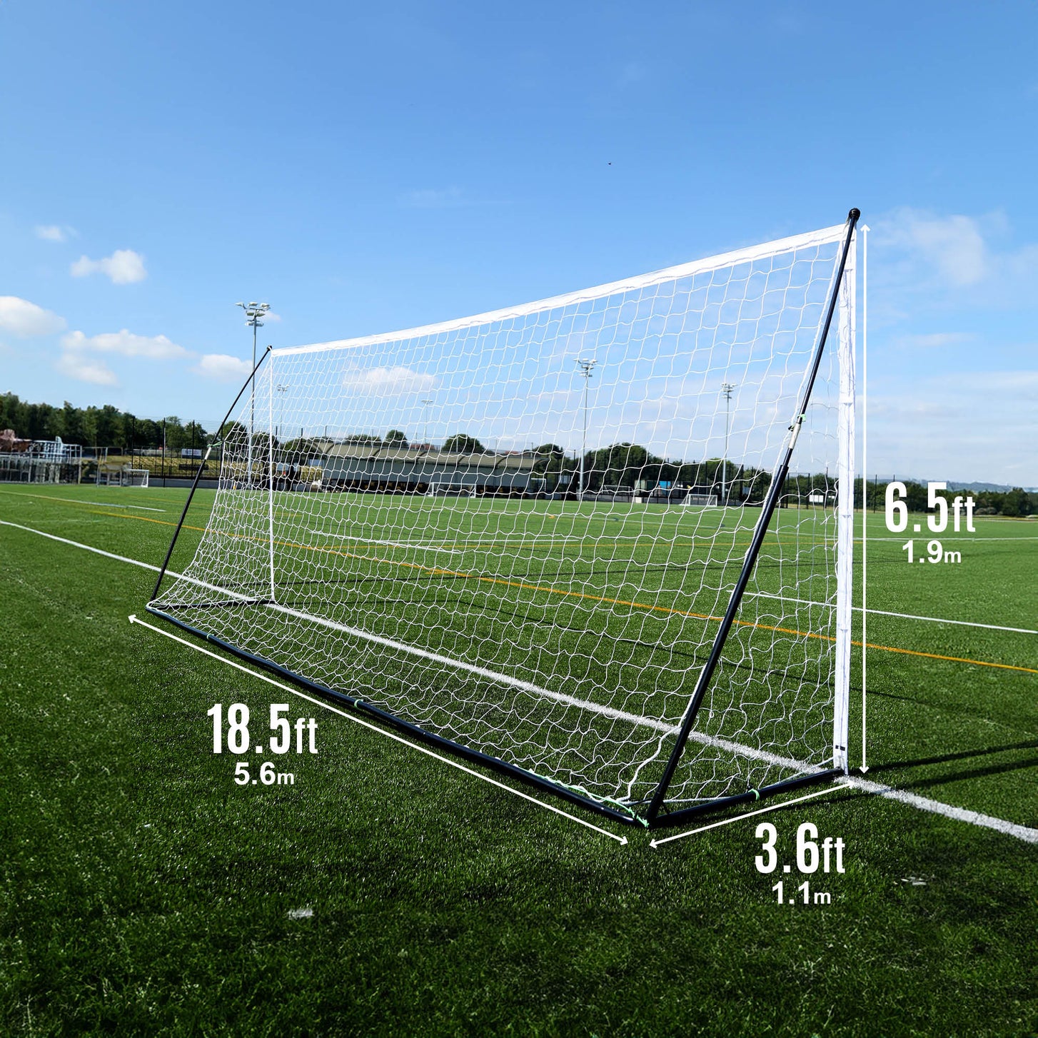 KICKSTER Elite 18.5x6.5' goal from the side on an artificial field, marked 18.5ft wide, 6.5ft high and 3.6ft deep.