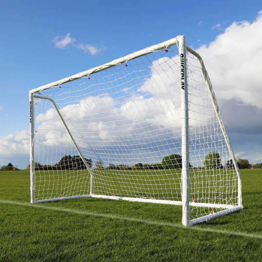 QUICKPLAY Q-FOLD Soccer goal on a grass field with a blue sky and clouds in the background