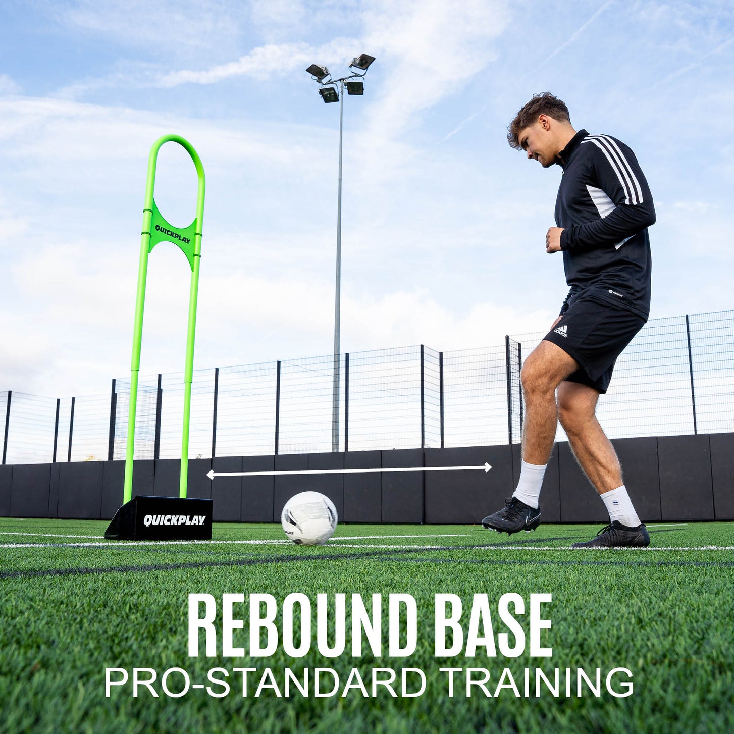 REPLAY Defender Airflow Mannequin on its black rebound base as a player strikes a ball toward it on artificial turf.