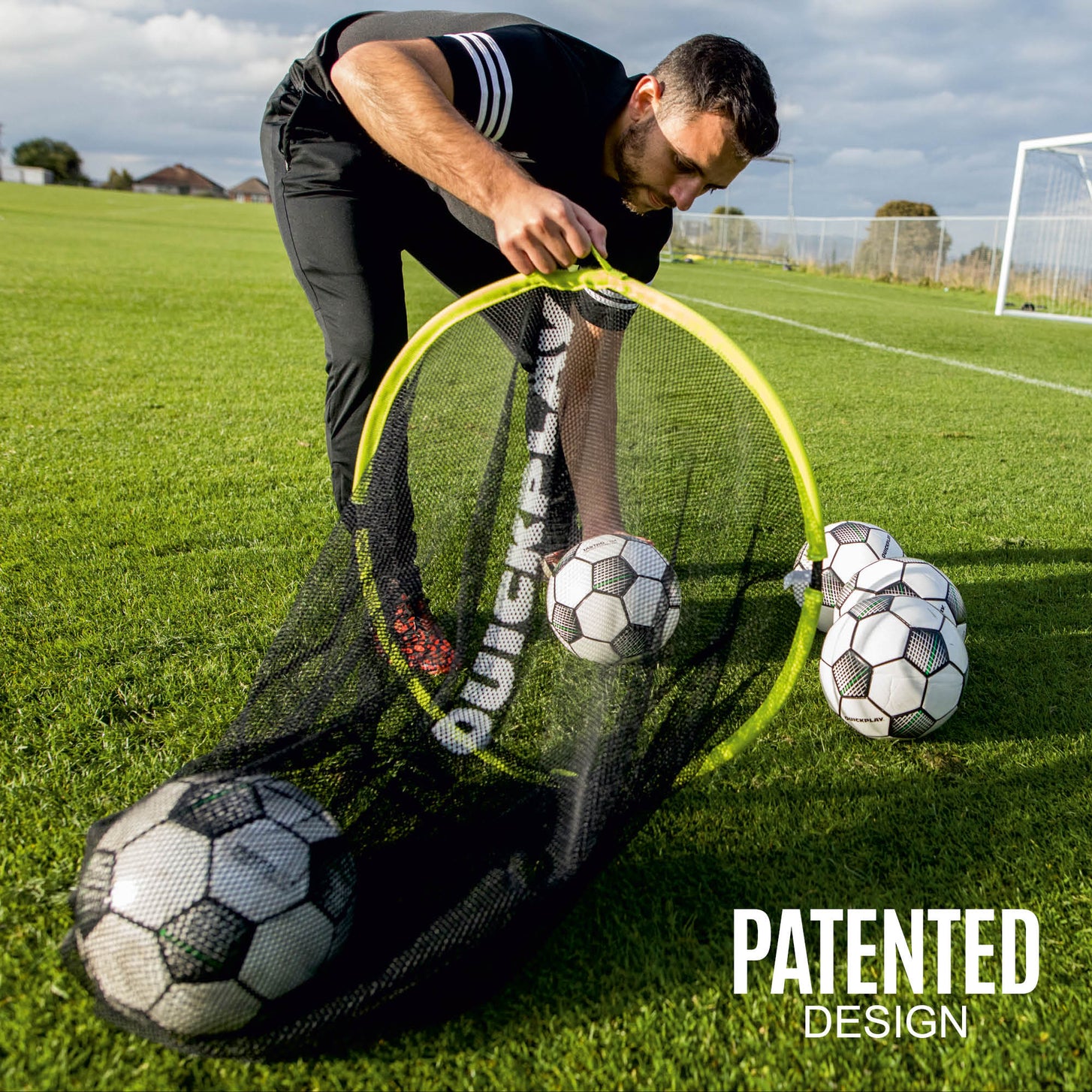 TARGET SAX: man on a grass field scooping soccer balls into the open bag through its neon green rim