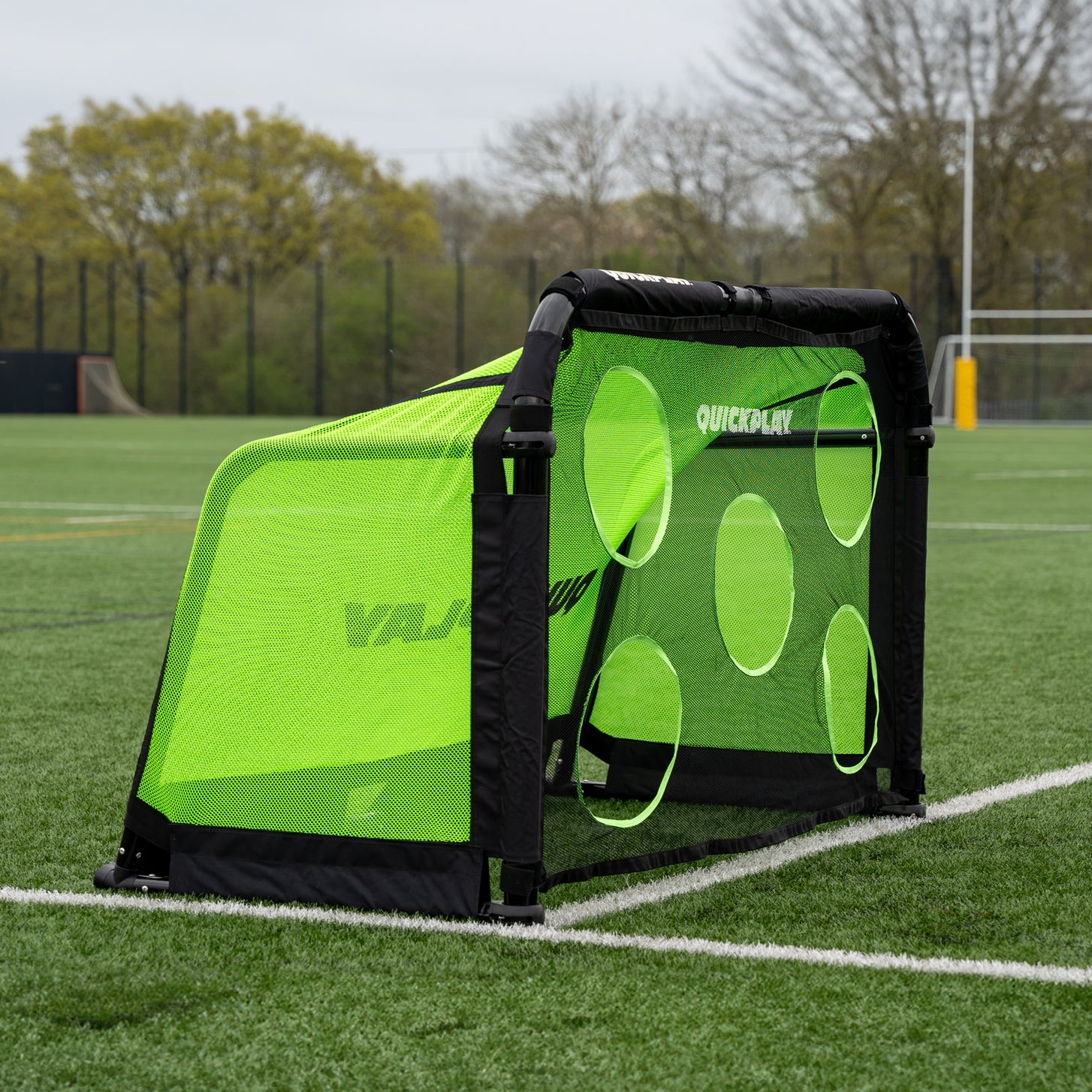 PRO ALU Training Target Net Lite 5x3' fitted to a black-framed goal, side view showing the green mesh sides and round target holes.
