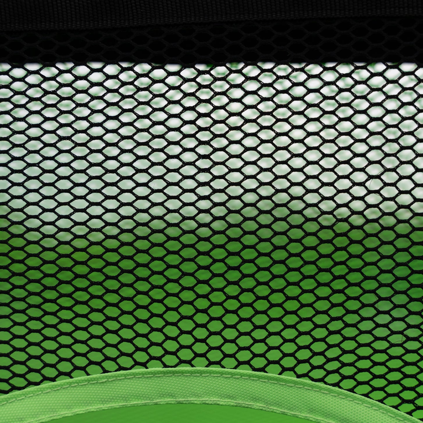 PRO ALU Training Target Net Lite 5x3': close-up of black hexagon mesh above the curved green edge of a target hole.