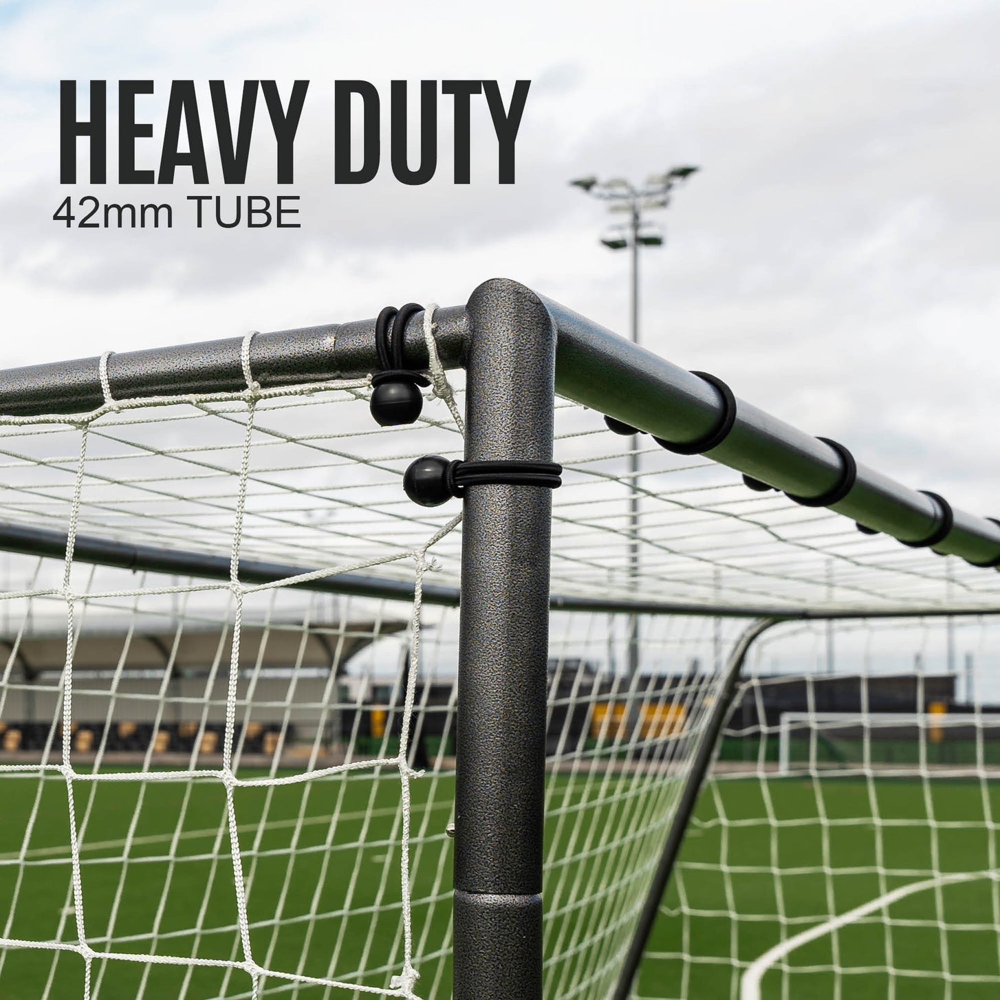 GS Series Soccer Goal 16x7' top corner close up, with black ball ties on the net, and the text "Heavy duty, 42mm tube".