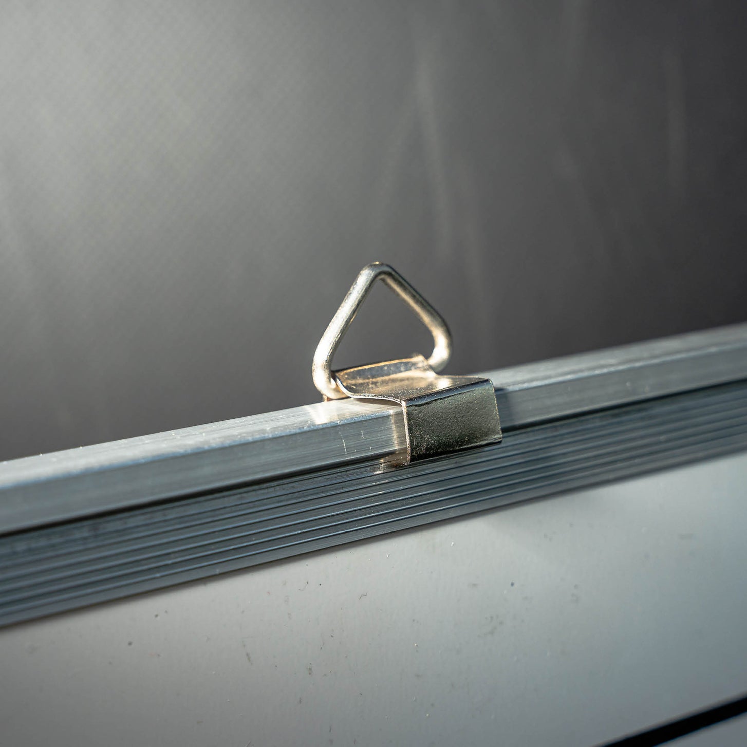 Soccer Coaching Magnetic Whiteboard (S) 12x18in: the metal hanging loop clipped to the top of the silver frame, close up.