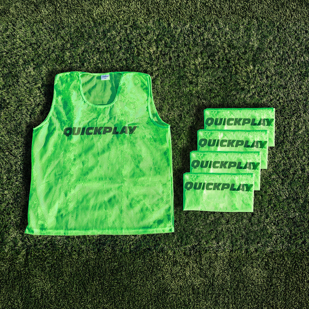 A green QUICKPLAY breathable mesh training vest.