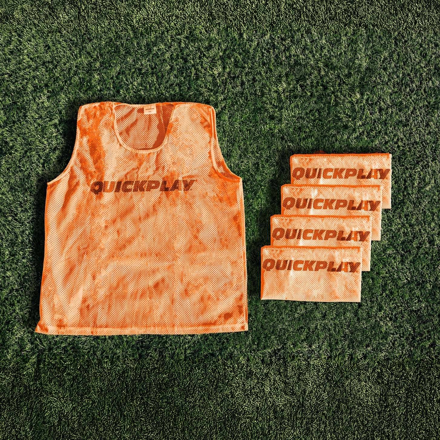 An orange QUICKPLAY breathable mesh training vest.