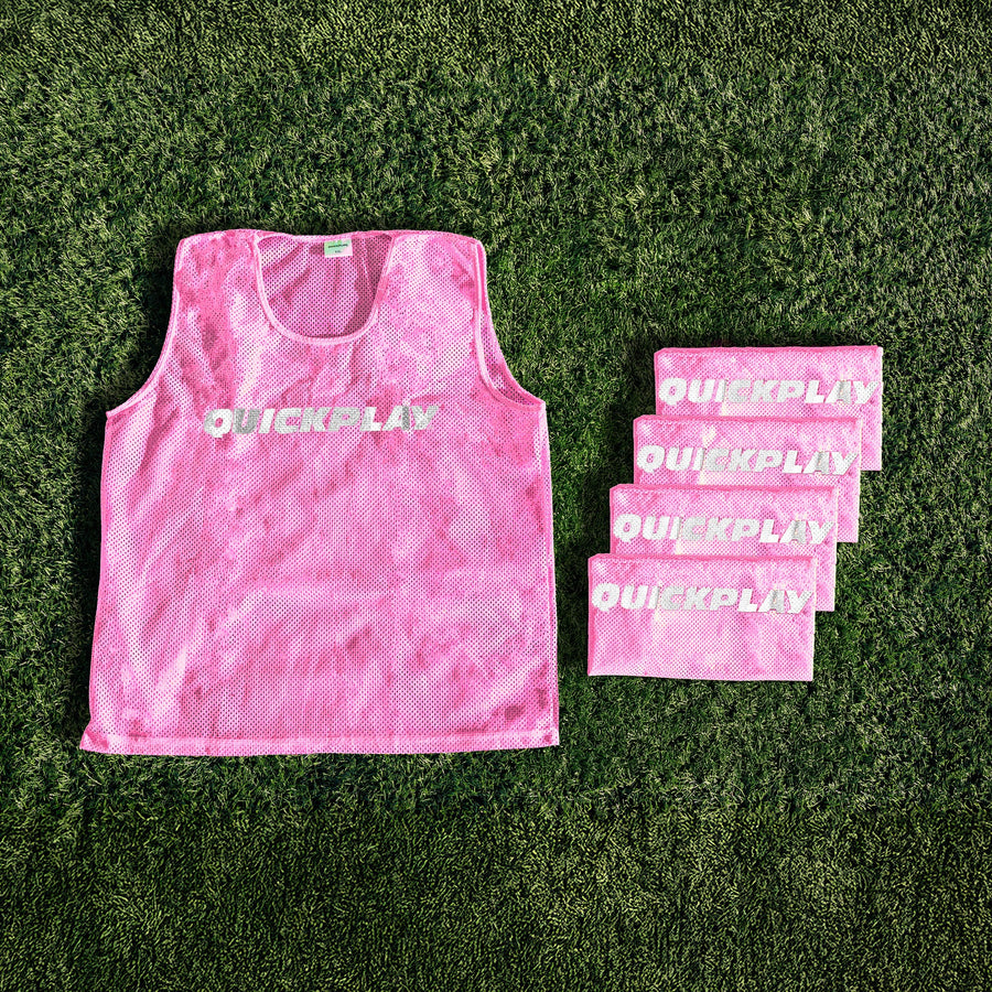 A pink QUICKPLAY breathable mesh training vest.