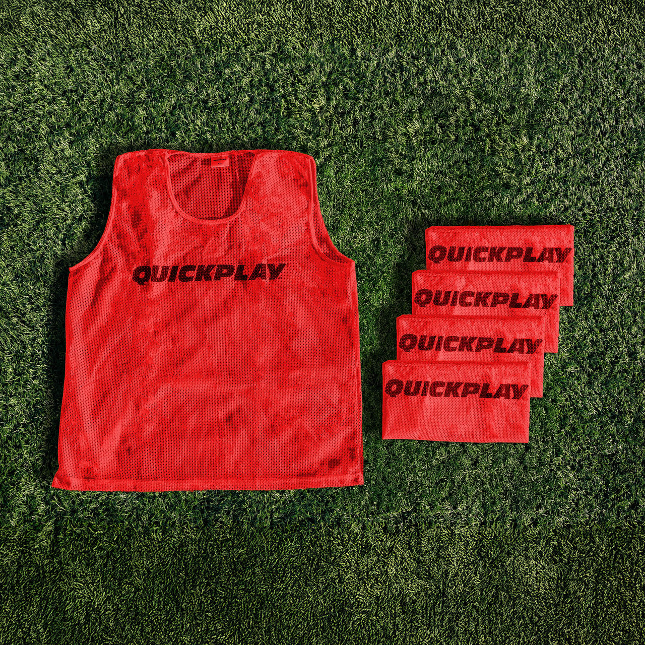 A red QUICKPLAY breathable mesh training vest.