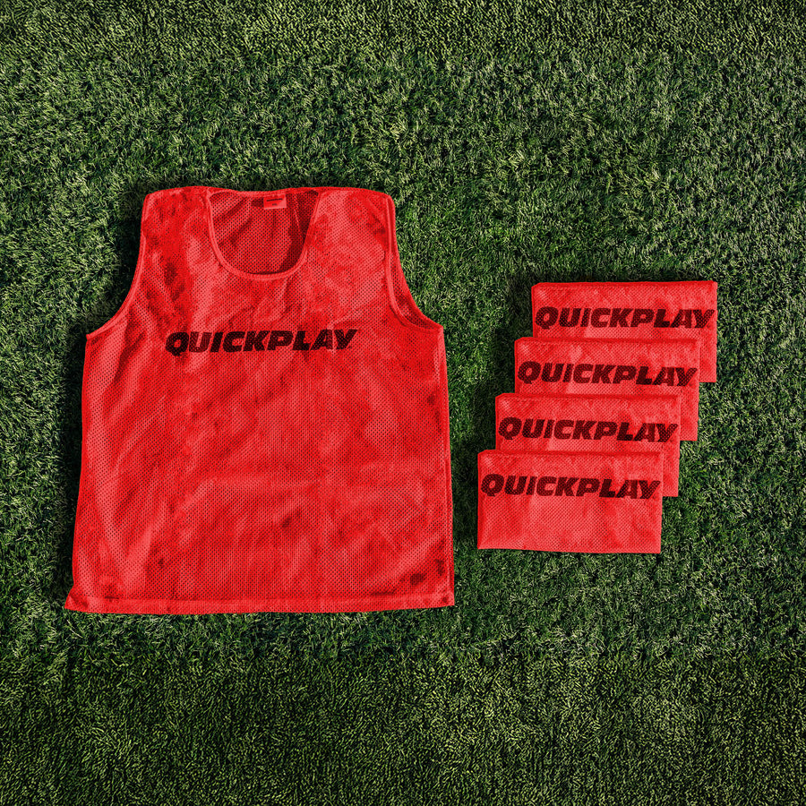 A red QUICKPLAY breathable mesh training vest.