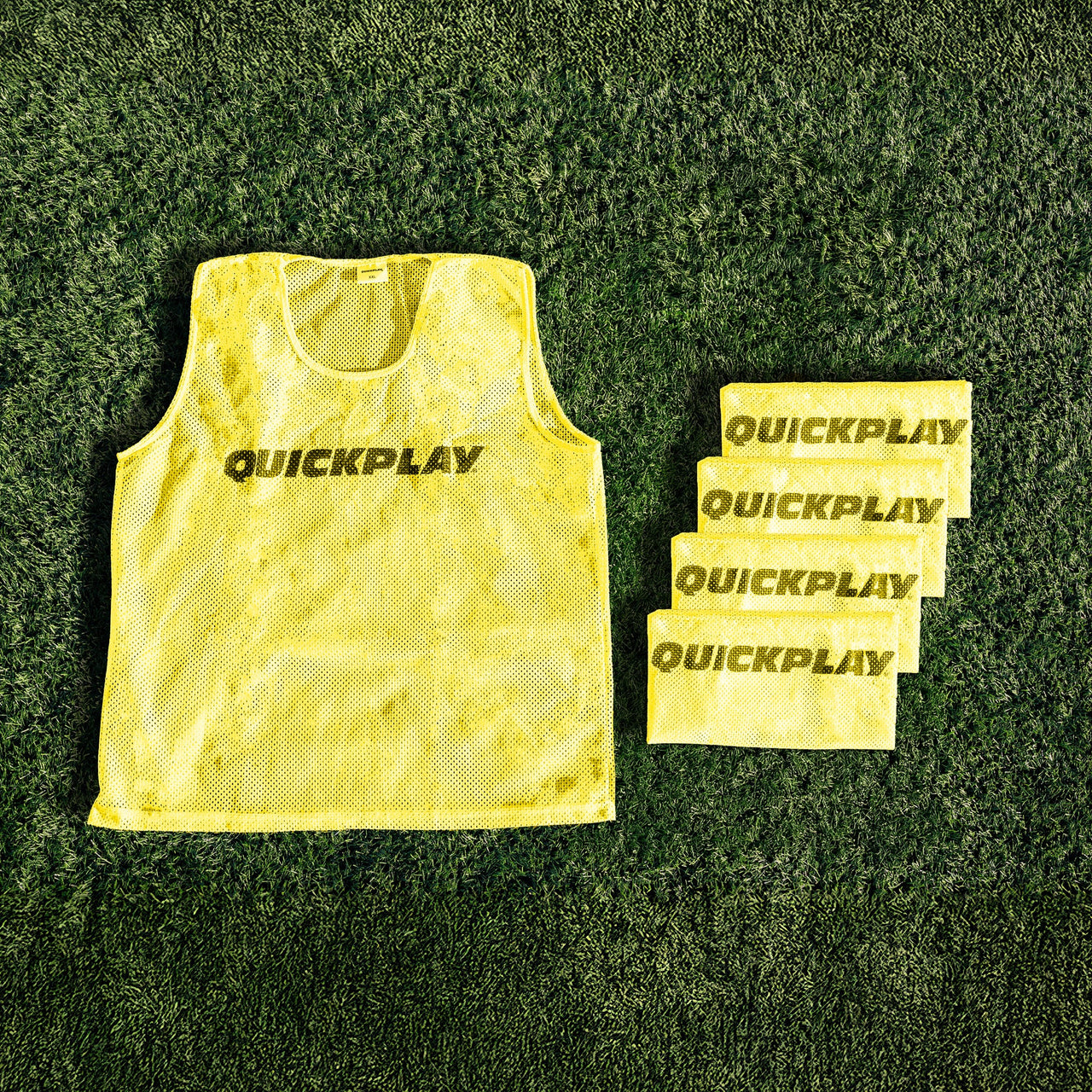 A yellow QUICKPLAY breathable mesh training vest.