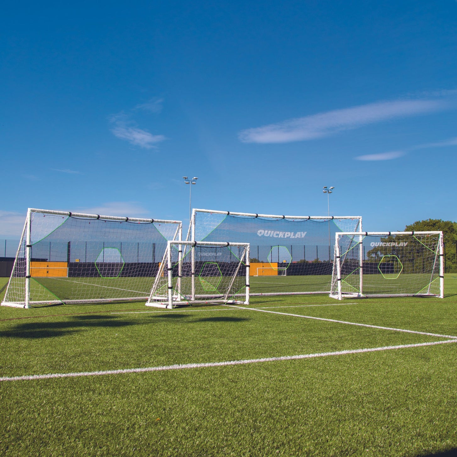 TARGET Net Lite 12x6': four goals of different sizes fitted with target nets standing on an artificial field