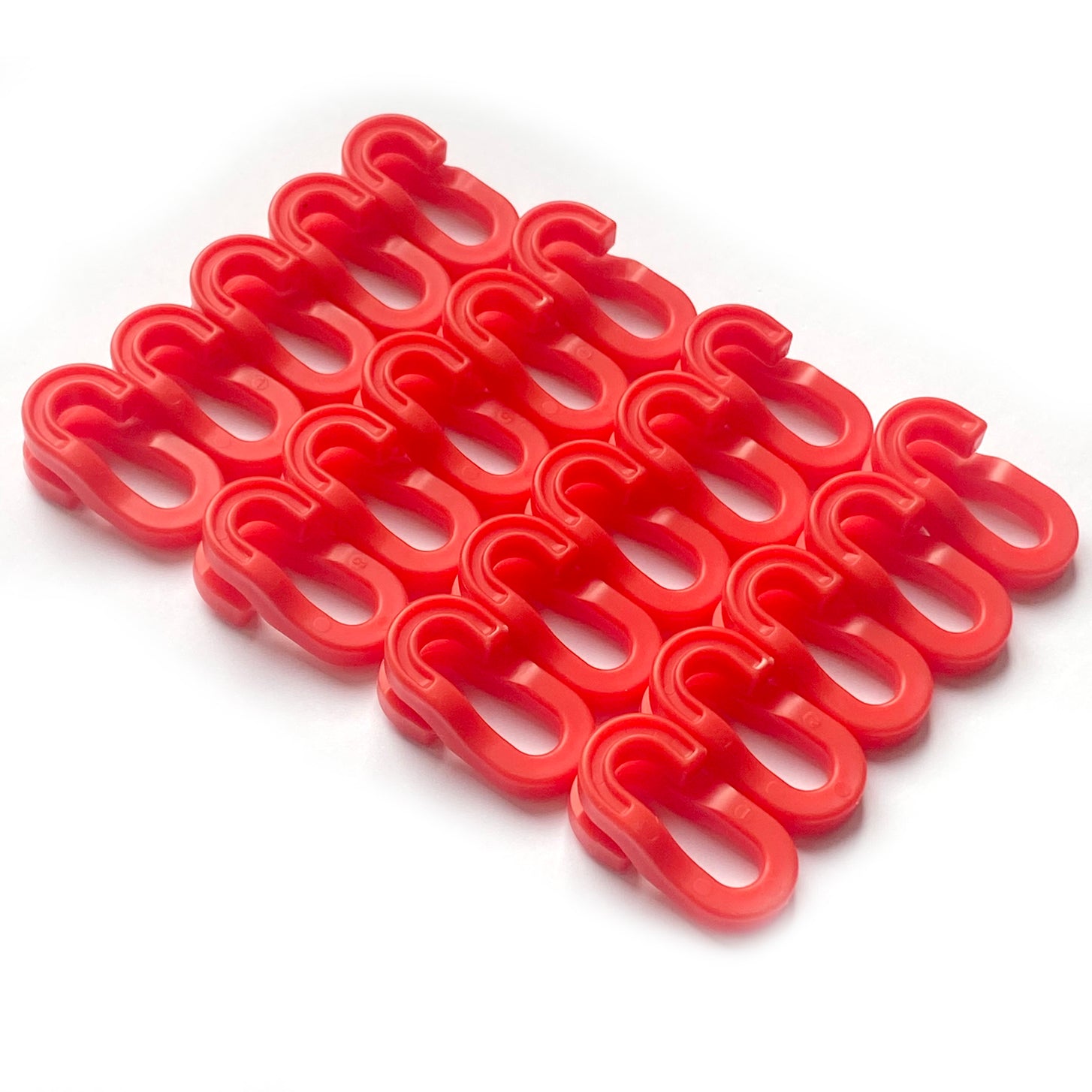 A group of red plastic Q-FOLD net clips on a white background.